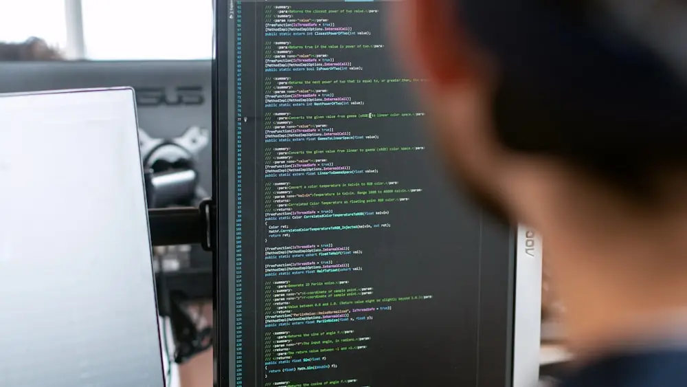 A developer reading code on a dark monitor