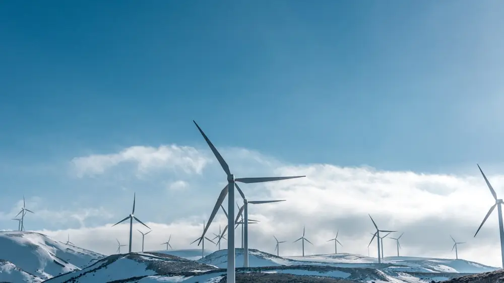 Wind turbines standing across an open ridge