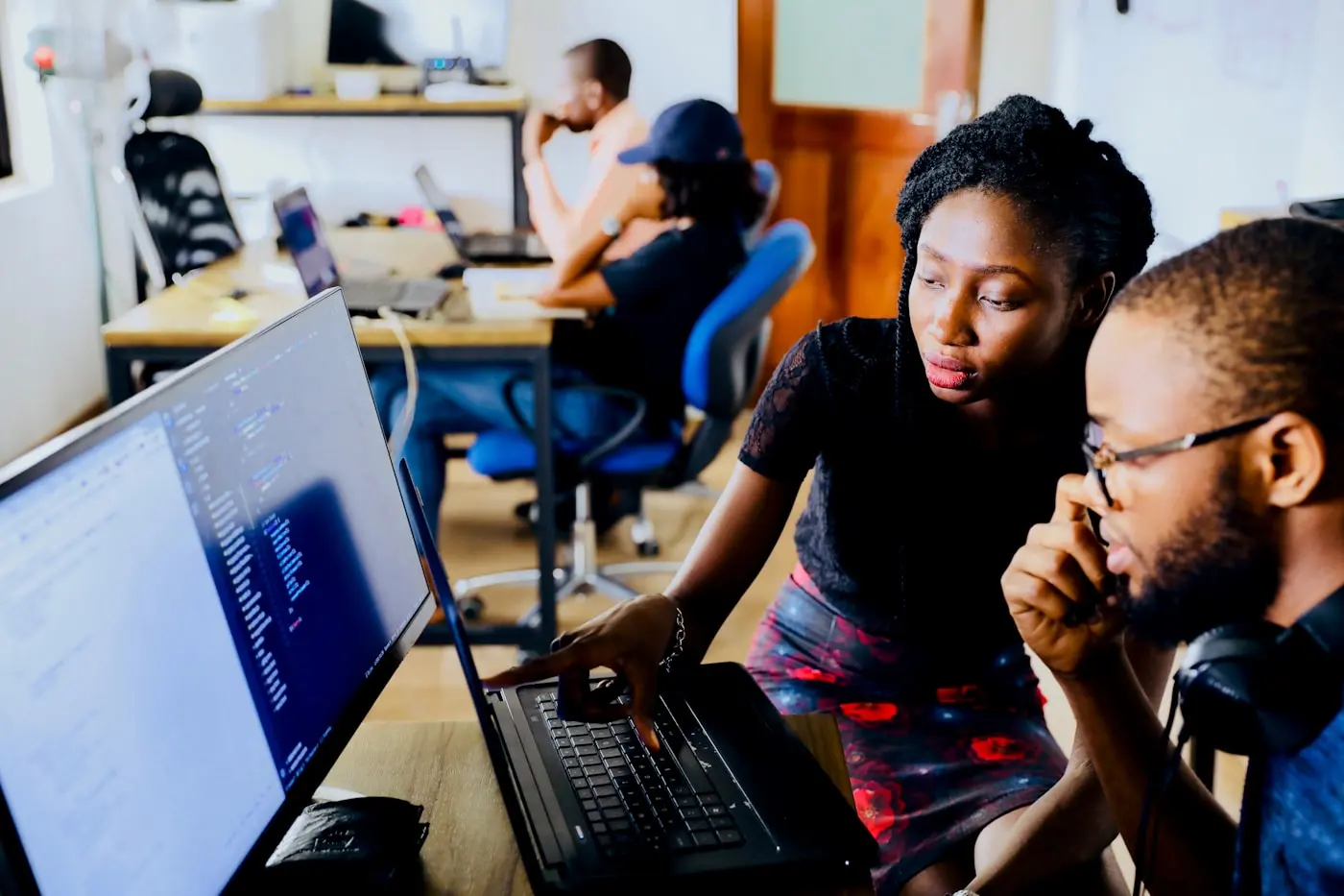Two colleagues working through something together at one screen