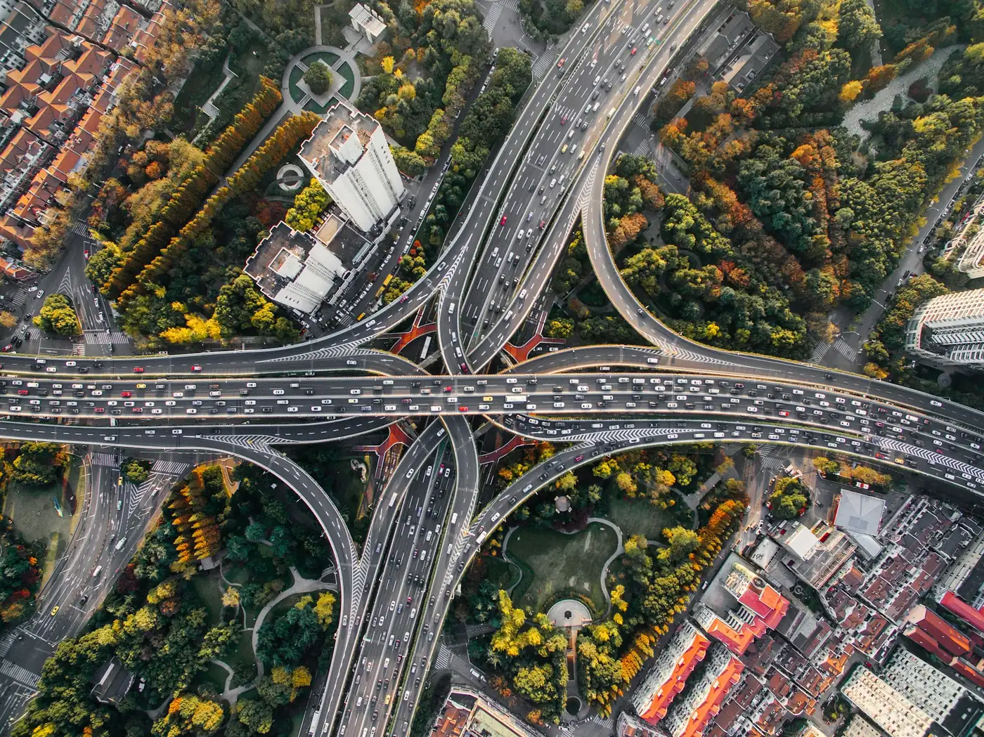 Aerial view of a multi-level road interchange, routes branching in every direction